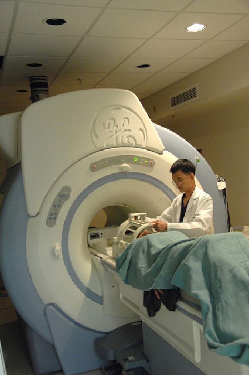 A doctor and patient using MRI.