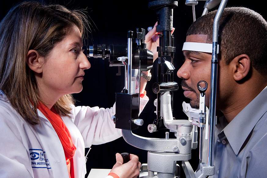 Eye care professional examines patient