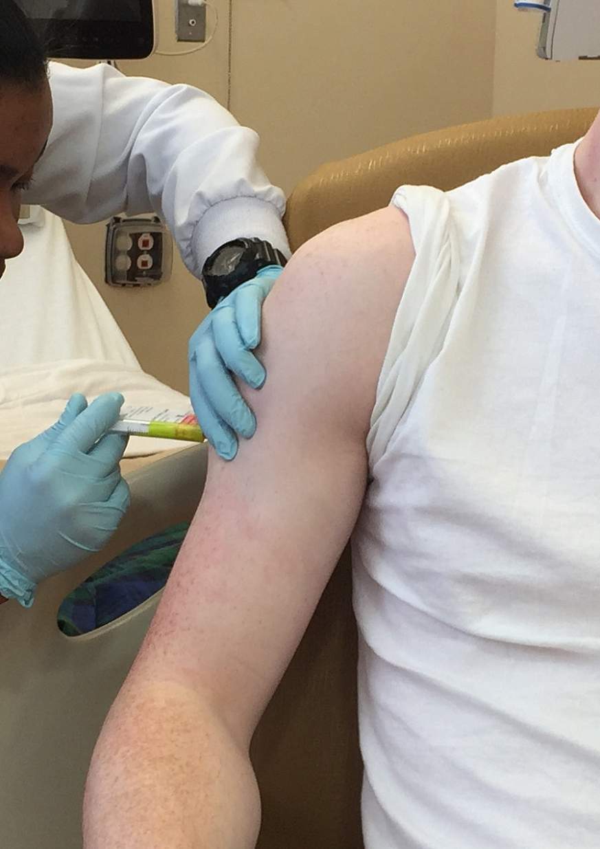 Image of a patient receiving a vaccine injection. 