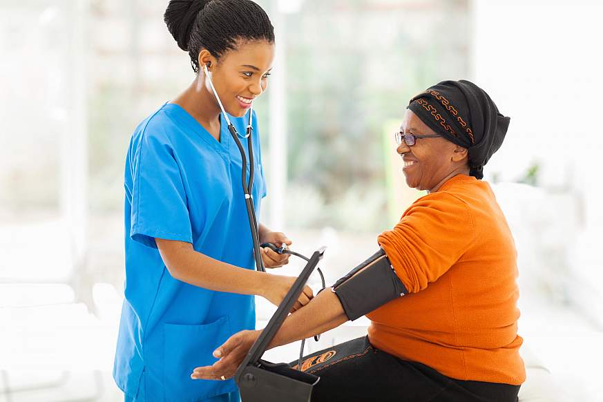 An overweight woman getting her blood pressure checked.