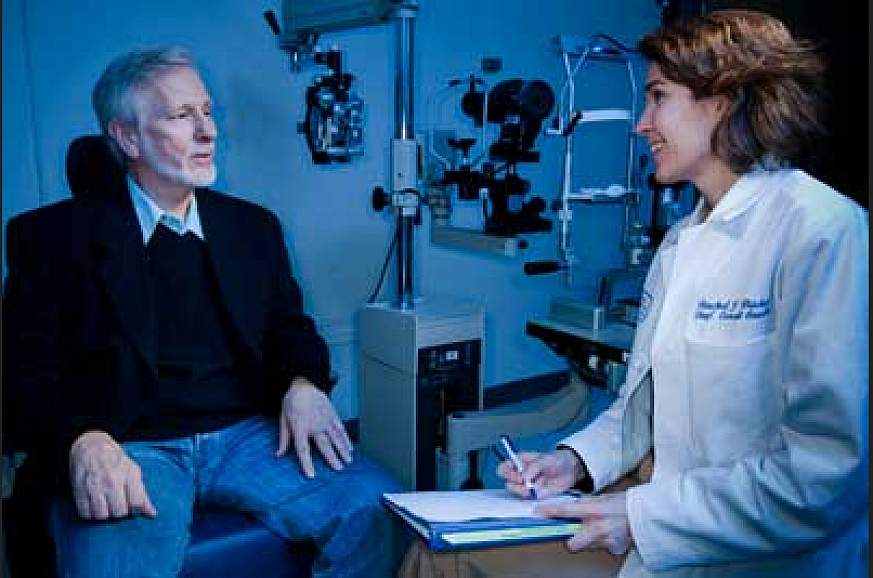 An eye care professional consults with a patient.