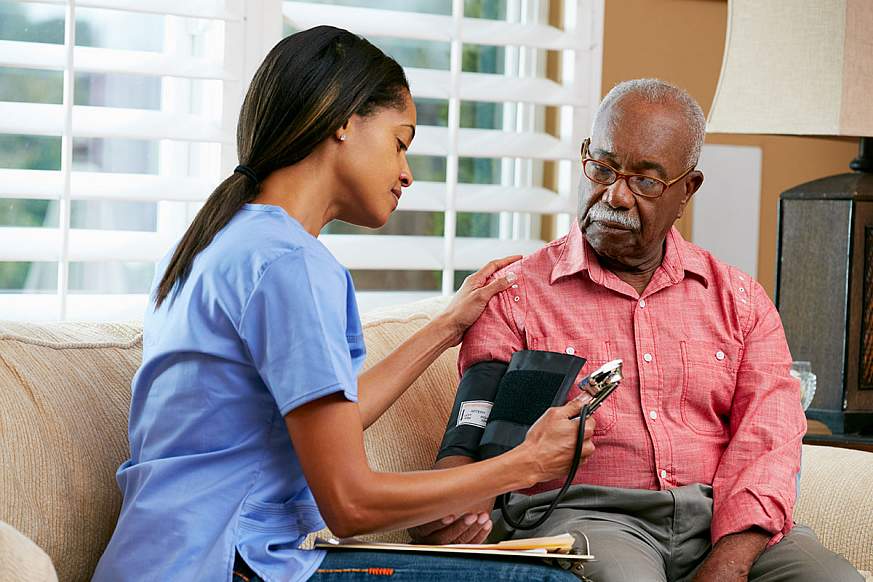 Image of a healthcare worker checking blood pressure