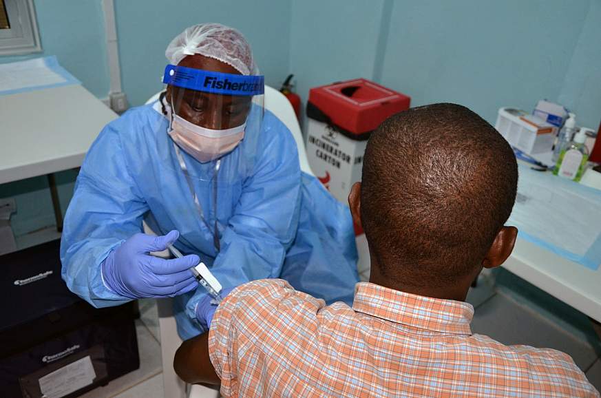 Image of a volunteer receiving a vaccine