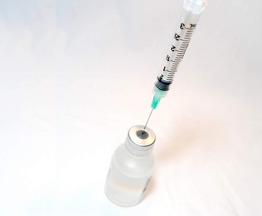 Needle syringe with a vaccine bottle.