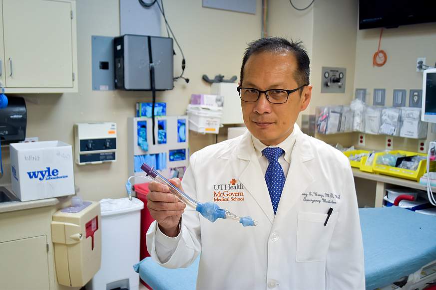 Image of Dr. Wang holding the laryngeal tube used in the study.