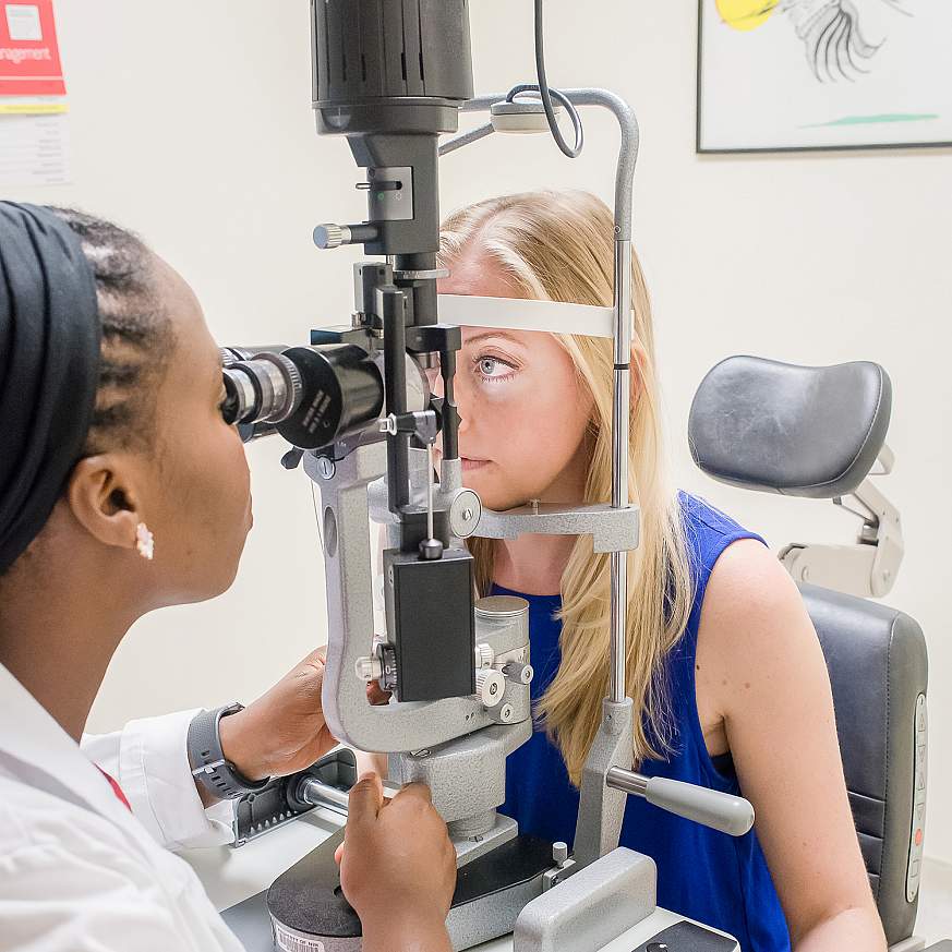 Physician examines patient’s eyes