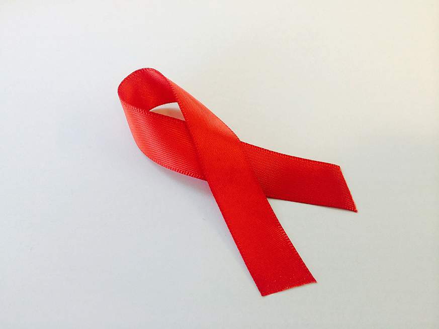 Red ribbon, the international symbol for AIDS awareness. 