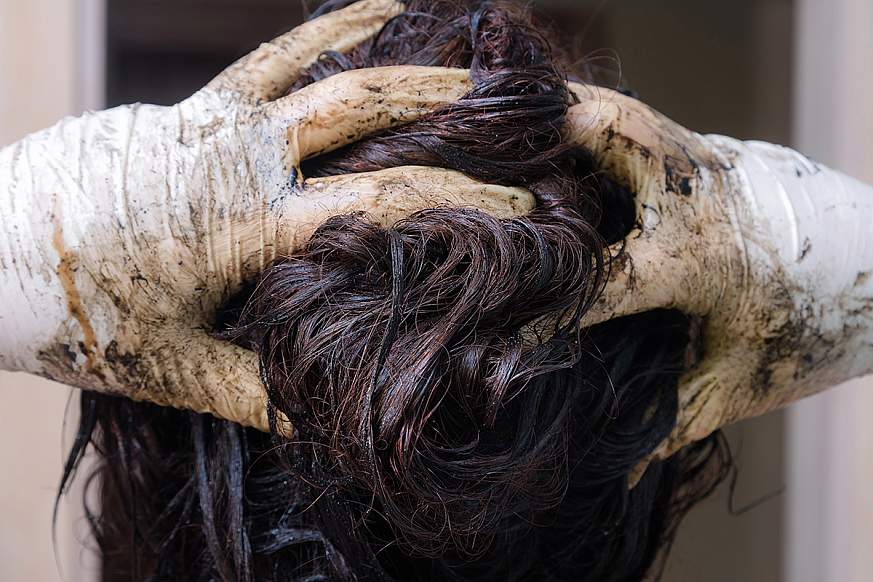 Image of a woman dyeing her hair.