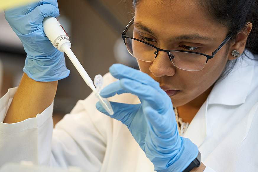 Young woman scientist working with a biosample