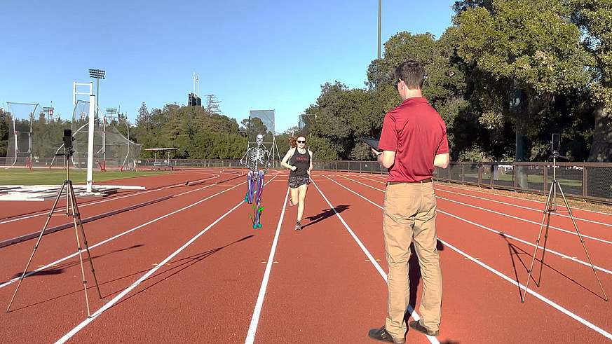 Image shows a researcher using two stationary smartphones to record a study participant jogging