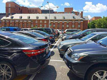 Parking lot filled with cars on the NIH campus.