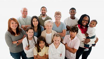 A diverse group of smiling people looking up at the camera.