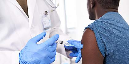 photo of a doctor giving an injection to a patient