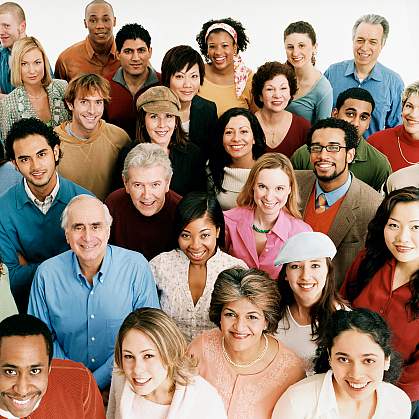 A group of people smiling and looking up toward the camera.