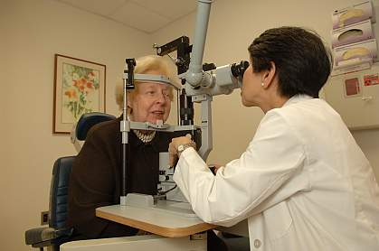 Image of a doctor performing an eye exam.