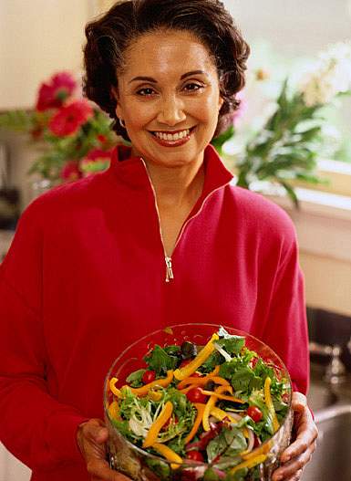 photo of a woman holding a salad