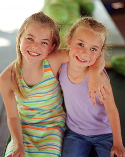 photo of two young girls smiling