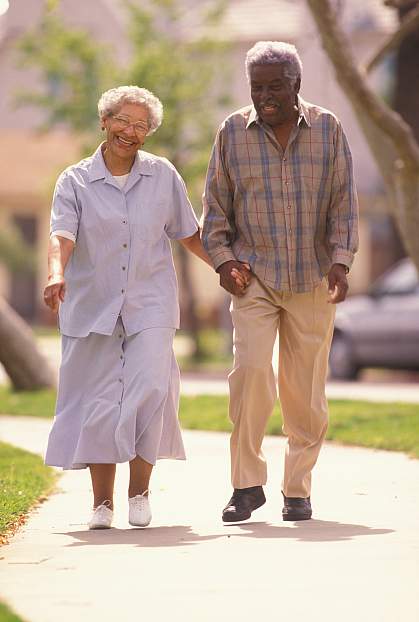 photo of an elderly couple walking