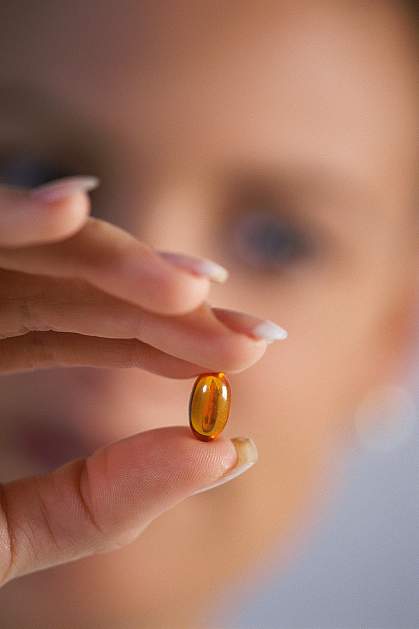 photo of a hand holding a mineral supplement