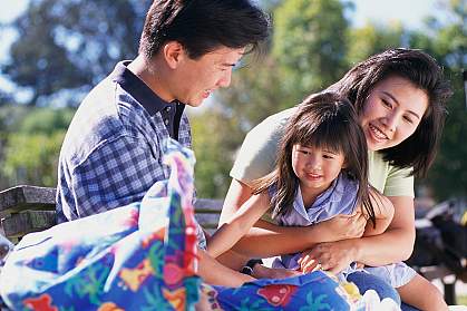 Picture of Family Sitting on Park Bench