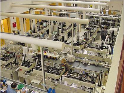 Bird's-eye view of large room with several people working on DNA sequencing equipment