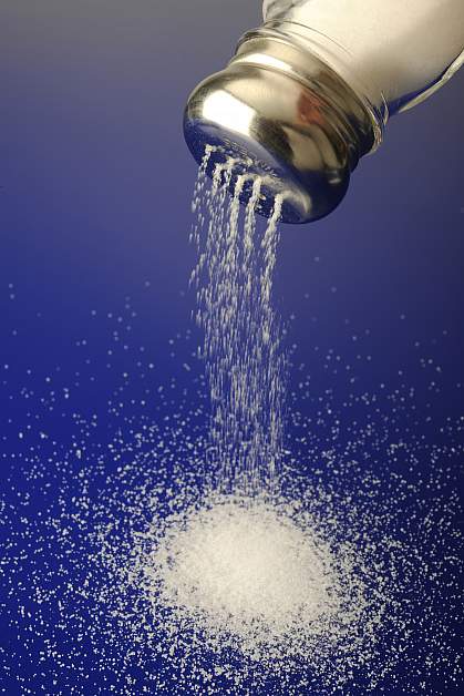 Photo of a salt shaker and spilled salt