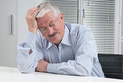 Photo of a man suffering with a migraine headache