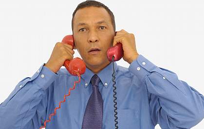 Picture of a man listening to two phones at the same time