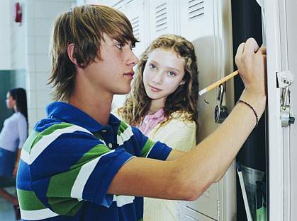 Teenage boy at his school locker