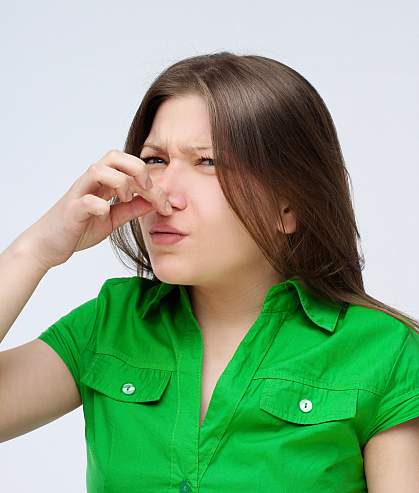 Photo of a woman holding her nose