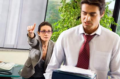 A female boss yelling at a male employee