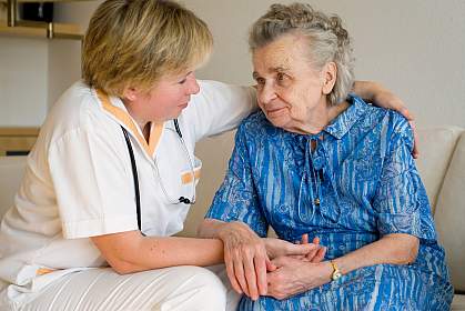 Photo of a nurse caring for an older woman