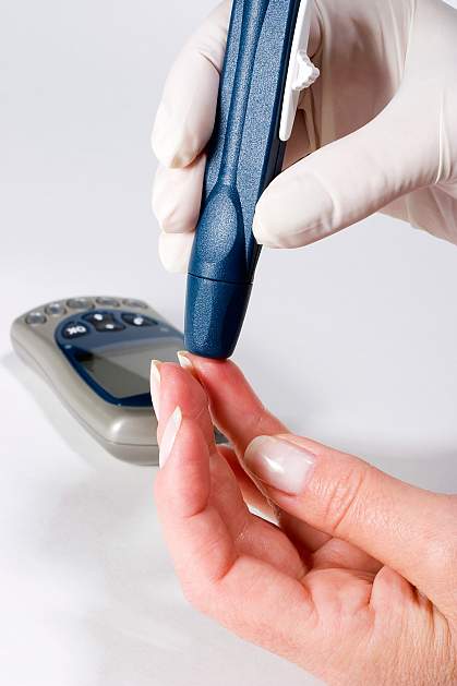Photo of a person administering a blood glucose test