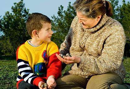 Photo of a mother and her young son talking