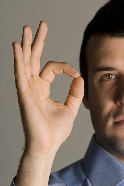 Photo of a man making the hand gesture for OK