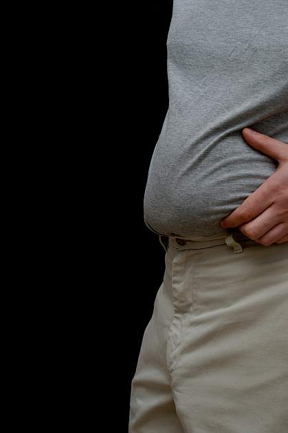 Photo of a man pinching his belly