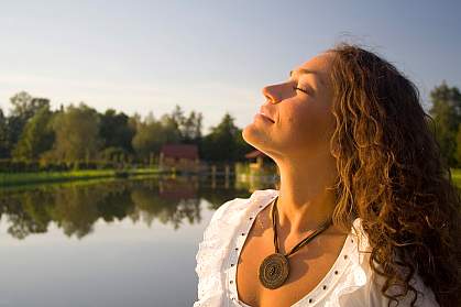 Photo of woman taking a deep breath