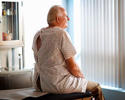 Photo of a man sitting on an examining table