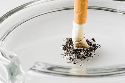 Photo of a cigarette stubbed out in an ashtray