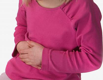 photo of a young girl holding her stomach
