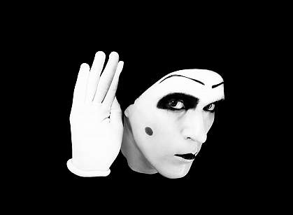 a photo of a mime holding his hand to his ear