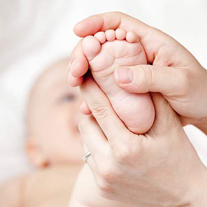 Photo of a newborn infant's foot held in a woman's hands
