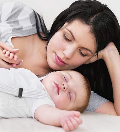 Photo of a woman and a sleeping baby