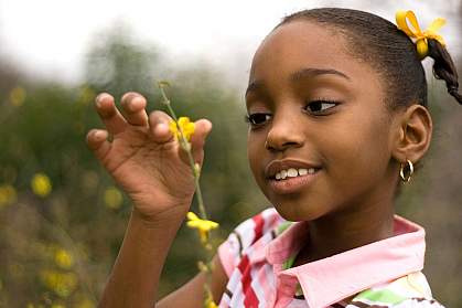 Photo of a little girl holding a flower
