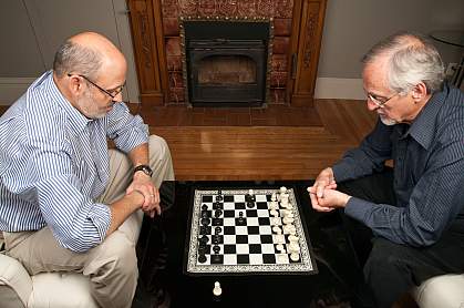 Photo of two older men playing chess