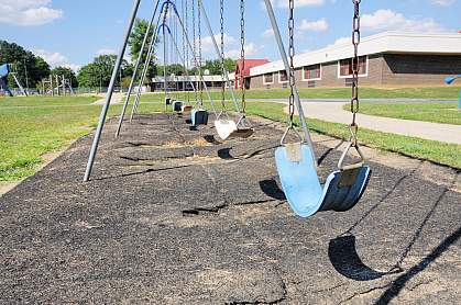Photo of empty swings outside an elementary school