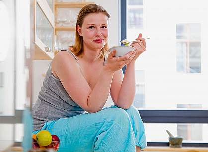 Photo of a woman eating yogurt
