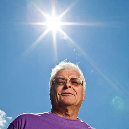 Older man with blazing sun.