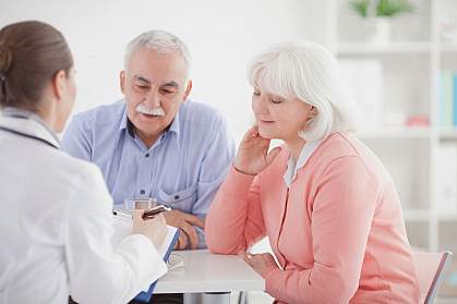 Older couple consulting with a doctor.