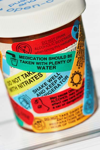 Pill bottle with many warning labels.